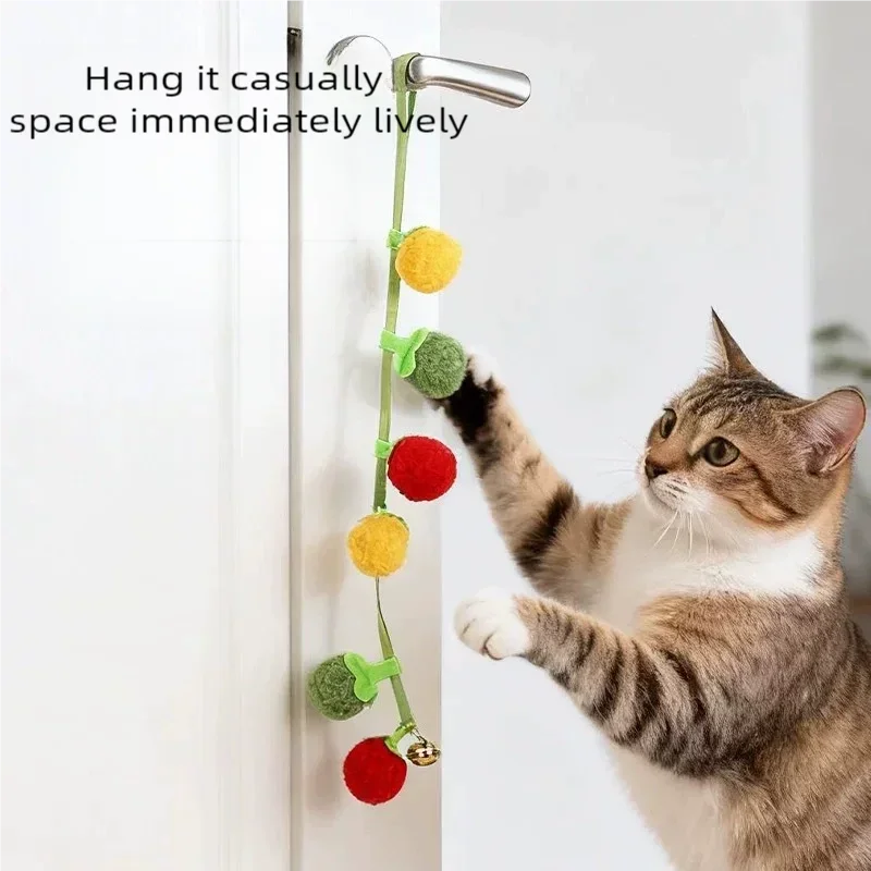 Interactive tomato-shaped cat toy with rope and bell