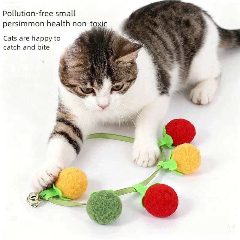 Interactive tomato-shaped cat toy with rope and bell